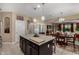 Open-concept kitchen with granite countertops, a central island, and seamless flow to the dining area at 23707 W Hess Ave, Buckeye, AZ 85326