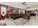 Inviting living room features tile floors, a ceiling fan, and a comfortable brown leather sofa set at 23707 W Hess Ave, Buckeye, AZ 85326