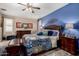 Bright main bedroom with a large bed and blue accent wall at 23707 W Hess Ave, Buckeye, AZ 85326