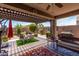 Beautiful outdoor patio area with a pergola, seating, and a barbecue grill, perfect for outdoor living at 23707 W Hess Ave, Buckeye, AZ 85326
