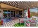 Inviting covered patio with outdoor seating and ceiling fan, perfect for relaxing and entertaining at 23707 W Hess Ave, Buckeye, AZ 85326
