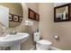 Well lit powder room with a round mirror and small sink at 23707 W Hess Ave, Buckeye, AZ 85326