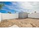 Spacious backyard with a storage shed, white fences, and ample space for outdoor activities at 2388 S Vista Rd, Apache Junction, AZ 85119