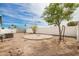 Backyard featuring a concrete pad, storage shed, and a white fence, perfect for various outdoor uses at 2388 S Vista Rd, Apache Junction, AZ 85119