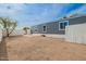 Backyard with a patio area next to the home and white fence surrounding the space at 2388 S Vista Rd, Apache Junction, AZ 85119