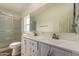 Bathroom with a dual sink vanity, large mirror, and a walk-in shower at 2388 S Vista Rd, Apache Junction, AZ 85119