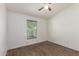Bedroom with wood-look floors, window with blinds, and ceiling fan with light at 2388 S Vista Rd, Apache Junction, AZ 85119