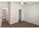 Bright bedroom featuring wood-look floors, closet, ceiling fan, and an en suite bathroom at 2388 S Vista Rd, Apache Junction, AZ 85119