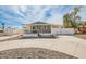 Charming home with covered porch and driveway, surrounded by a decorative rock landscape at 2388 S Vista Rd, Apache Junction, AZ 85119