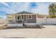 Inviting home exterior with a covered porch and carport, offering curb appeal and practicality at 2388 S Vista Rd, Apache Junction, AZ 85119