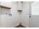 Bright laundry room with a door to the backyard, washer and dryer hookups, and cabinets at 2388 S Vista Rd, Apache Junction, AZ 85119