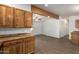 Open floor plan connecting kitchen and living room with wood beam and vinyl floors at 2388 S Vista Rd, Apache Junction, AZ 85119