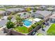 Well-manicured backyard with a beautiful pool, covered patio, putting green, and lush landscaping at 25421 S 228Th St, Queen Creek, AZ 85142