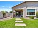 Well-maintained backyard with artificial turf, stepping stones, and a covered patio area at 25421 S 228Th St, Queen Creek, AZ 85142