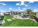 Outdoor oasis with a pool, spa, pergola, and well-maintained turf, ideal for entertaining at 25421 S 228Th St, Queen Creek, AZ 85142