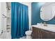 This bathroom features a shower with a curtain and a sink with a round mirror at 25421 S 228Th St, Queen Creek, AZ 85142