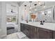 Stylish bathroom with double sinks, modern lighting, and a view into the bedroom and shower at 25421 S 228Th St, Queen Creek, AZ 85142