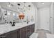 Bright bathroom featuring a double sink vanity with a large mirror and modern light fixtures at 25421 S 228Th St, Queen Creek, AZ 85142