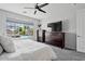 Bedroom with a large window, bed, ceiling fan, and a TV at 25421 S 228Th St, Queen Creek, AZ 85142