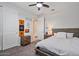 Cozy bedroom with neutral tones, ceiling fan, bedside tables, and a comfortable bed at 25421 S 228Th St, Queen Creek, AZ 85142