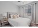 Bright bedroom with a comfortable queen-sized bed, neutral tones, and natural light from the window at 25421 S 228Th St, Queen Creek, AZ 85142