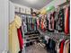 Walk-in closet with built-in shelving and organized storage for clothing and shoes at 25421 S 228Th St, Queen Creek, AZ 85142
