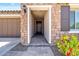 Inviting entryway with stone accents, a tiled walkway, and colorful flowerbeds at 25421 S 228Th St, Queen Creek, AZ 85142