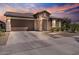 Stunning home featuring a stone facade, two-car garage, and a beautifully landscaped front yard at 25421 S 228Th St, Queen Creek, AZ 85142