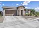 Charming home featuring a stone facade, two-car garage, and a well-manicured front yard at 25421 S 228Th St, Queen Creek, AZ 85142