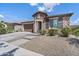 Attractive single-story home with stone accents, a two-car garage, and desert-friendly landscaping at 25421 S 228Th St, Queen Creek, AZ 85142