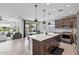 Open-concept kitchen features a center island with pendant lighting and stainless steel appliances at 25421 S 228Th St, Queen Creek, AZ 85142