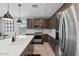 Modern kitchen with a large center island, stainless steel appliances, and stylish pendant lights at 25421 S 228Th St, Queen Creek, AZ 85142