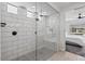 Modern walk-in shower with white subway tile and a rainfall shower head, adjacent to the main bedroom at 25421 S 228Th St, Queen Creek, AZ 85142