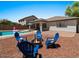 Entertainer's backyard complete with fire pit, seating, and in-ground pool at 271 W Roadrunner Dr, Chandler, AZ 85286