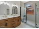 Modern bathroom featuring double sinks, stylish mirrors, and a luxurious glass-enclosed shower at 271 W Roadrunner Dr, Chandler, AZ 85286
