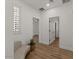 Hallway with wood floors, neutral walls, natural light and stylish bench at 271 W Roadrunner Dr, Chandler, AZ 85286