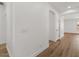 Bright hallway featuring arched doorways and attractive wood-look flooring at 271 W Roadrunner Dr, Chandler, AZ 85286