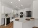 Bright kitchen features white cabinets, granite countertops, stainless steel appliances, and island seating at 271 W Roadrunner Dr, Chandler, AZ 85286