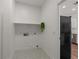 Laundry room with overhead shelf and geometric tile flooring at 271 W Roadrunner Dr, Chandler, AZ 85286