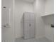 Clean and organized laundry room with storage cabinet and geometric-patterned tile at 271 W Roadrunner Dr, Chandler, AZ 85286