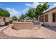 Backyard with a built-in grill and a tiled patio, perfect for outdoor cooking at 3152 E San Pedro Ct, Gilbert, AZ 85234