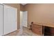 Neutral bedroom with sliding closet doors, a small desk, and a light tiled floor at 3152 E San Pedro Ct, Gilbert, AZ 85234