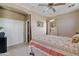 Bright bedroom featuring a ceiling fan, closet, and a window providing ample natural light at 3152 E San Pedro Ct, Gilbert, AZ 85234