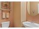 Stylish half-bathroom featuring a decorative mirror and a mounted towel rack at 3152 E San Pedro Ct, Gilbert, AZ 85234