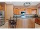 Kitchen features a stainless steel refrigerator, wooden cabinets, granite countertops and a kitchen island at 3152 E San Pedro Ct, Gilbert, AZ 85234