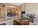 Living room with carpet, a coffee table, and a fireplace that leads to a formal dining room at 3152 E San Pedro Ct, Gilbert, AZ 85234