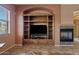 Living room with custom media center and fireplace at 3152 E San Pedro Ct, Gilbert, AZ 85234