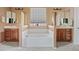 Bathroom with a tub, dual vanities, and neutral paint at 3152 E San Pedro Ct, Gilbert, AZ 85234