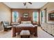 Spacious bedroom with carpet, a wood bed frame, many windows, and neutral paint at 3152 E San Pedro Ct, Gilbert, AZ 85234