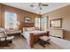 Spacious bedroom with carpet, a wood bed frame, many windows, and neutral paint at 3152 E San Pedro Ct, Gilbert, AZ 85234